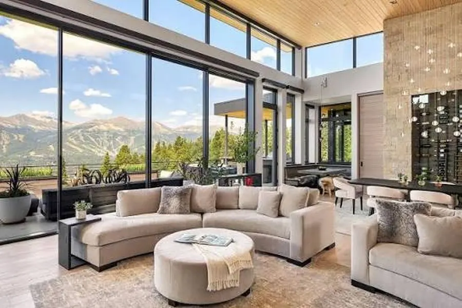 Great room with a wall of untinted glass washing out the view