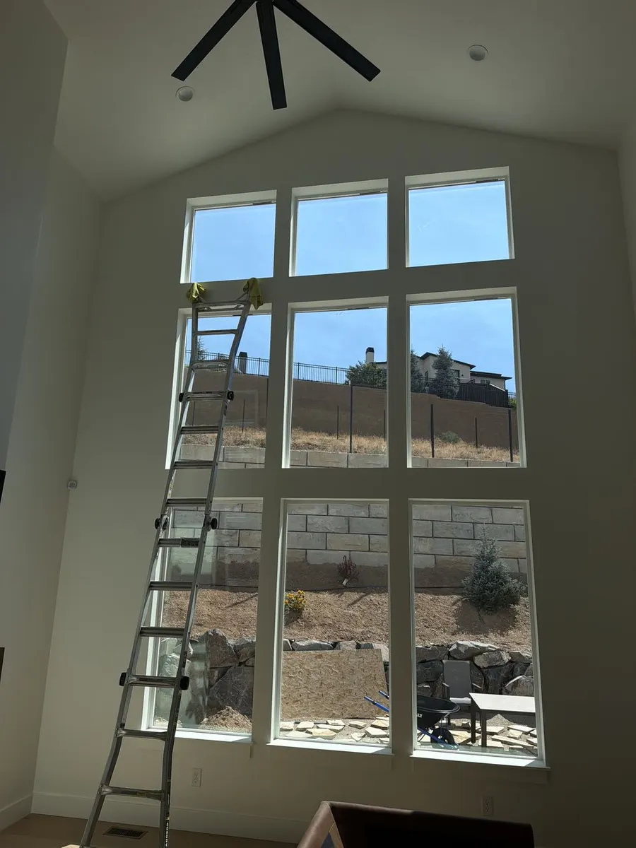A Sleek installer applying window film to a residential window